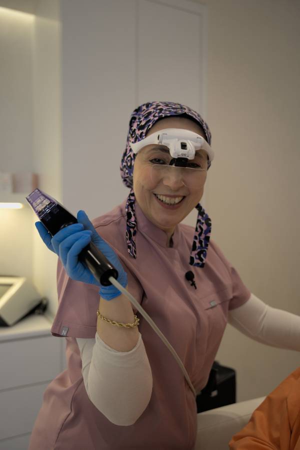 Doctor holding a skin treatment device